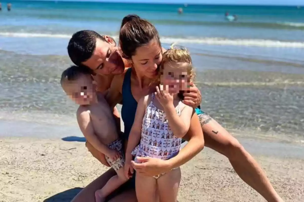 Familia abrazándose y sonriendo en la orilla de la playa con el mar de fondo Familia abrazándose y sonriendo en la orilla de la playa con el mar de fondo