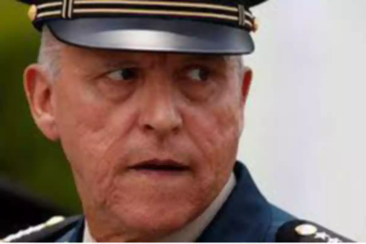 Un hombre con uniforme militar y gorra mirando hacia un lado.