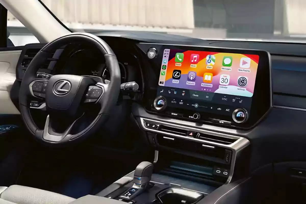 Interior de un automóvil Lexus con volante multifunción y una pantalla central grande mostrando el sistema de infoentretenimiento con aplicaciones conectadas Interior de un automóvil Lexus con volante multifunción y una pantalla central grande mostrando el sistema de infoentretenimiento con aplicaciones conectadas