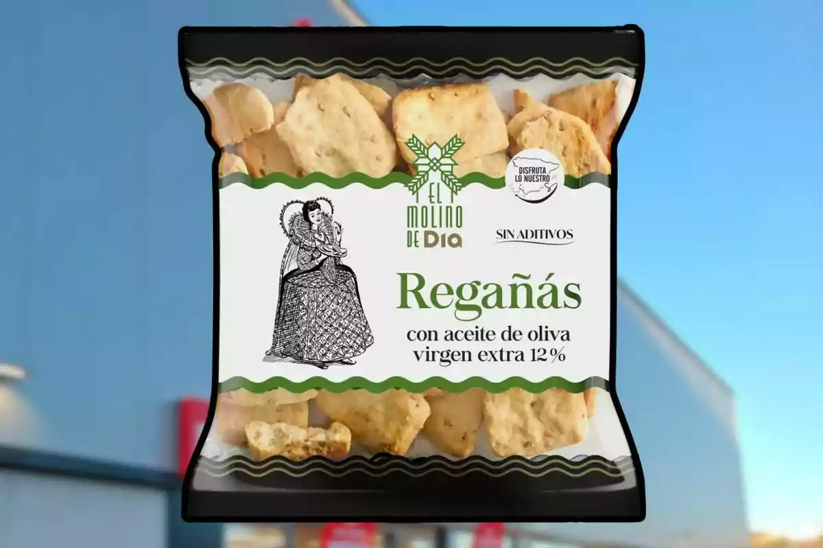 Bolsa de regañás El Molino de Dia con aceite de oliva virgen extra 12% sin aditivos sobre un fondo desenfocado de edificio azul Bolsa de regañás El Molino de Dia con aceite de oliva virgen extra 12% sin aditivos sobre un fondo desenfocado de edificio azul