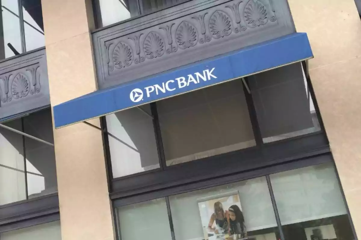 Facade of a PNC bank with a blue awning and large windows. Facade of a PNC bank with a blue awning and large windows.