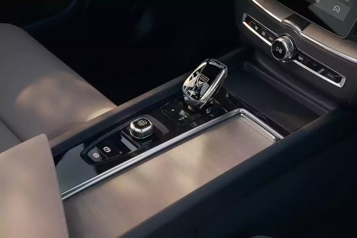 Interior de un Volvo XC60 T& B5 AWD Mild‑Hybrid moderno con palanca de cambios de cristal y acabados en madera y metal pulido en la consola central Interior de un Volvo XC60 T& B5 AWD Mild‑Hybrid moderno con palanca de cambios de cristal y acabados en madera y metal pulido en la consola central
