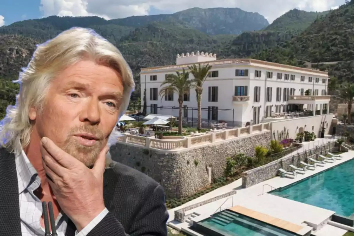 Hombre de cabello canoso y barba pensativo en primer plano con una gran mansión blanca y piscina al fondo rodeada de montañas y vegetación Hombre de cabello canoso y barba pensativo en primer plano con una gran mansión blanca y piscina al fondo rodeada de montañas y vegetación