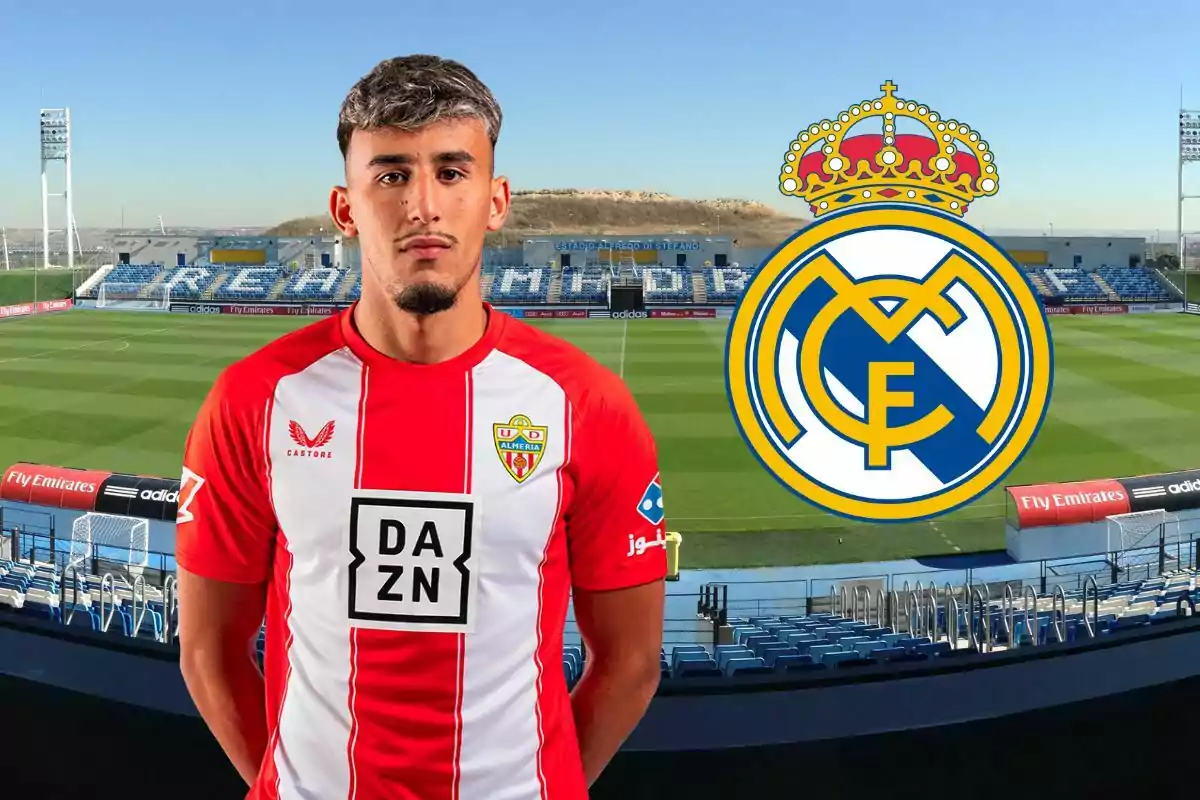 Futbolista del Almería posando en un estadio con el escudo del Real Madrid a su lado