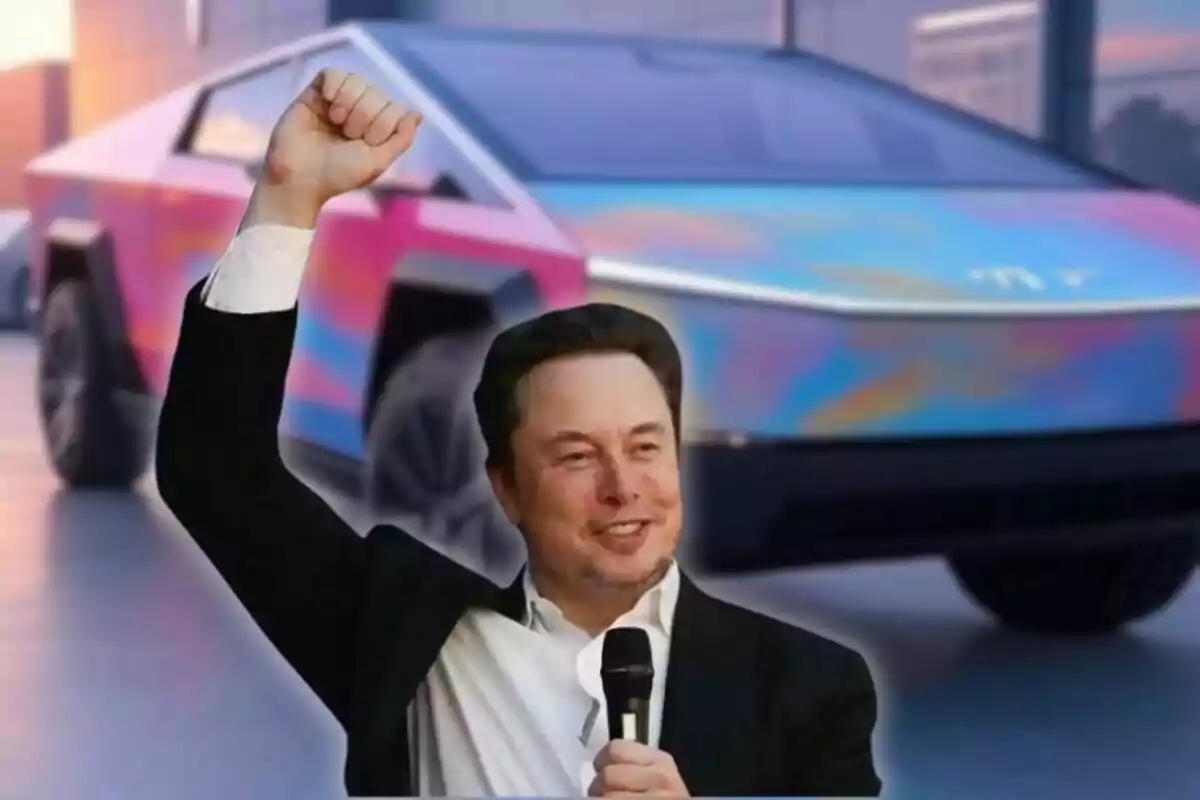 Smiling man with a microphone raising his fist in front of a futuristic, brightly colored van