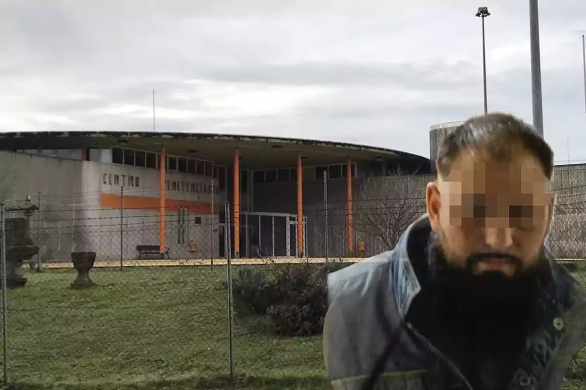 Un hombre con el rostro pixelado está frente a un edificio identificado como centro penitenciario, rodeado de una cerca de alambre y césped.