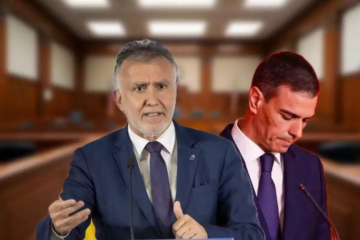 Dos hombres con traje en primer plano, uno hablando y el otro cabizbajo, en una sala que parece un tribunal o juzgado.