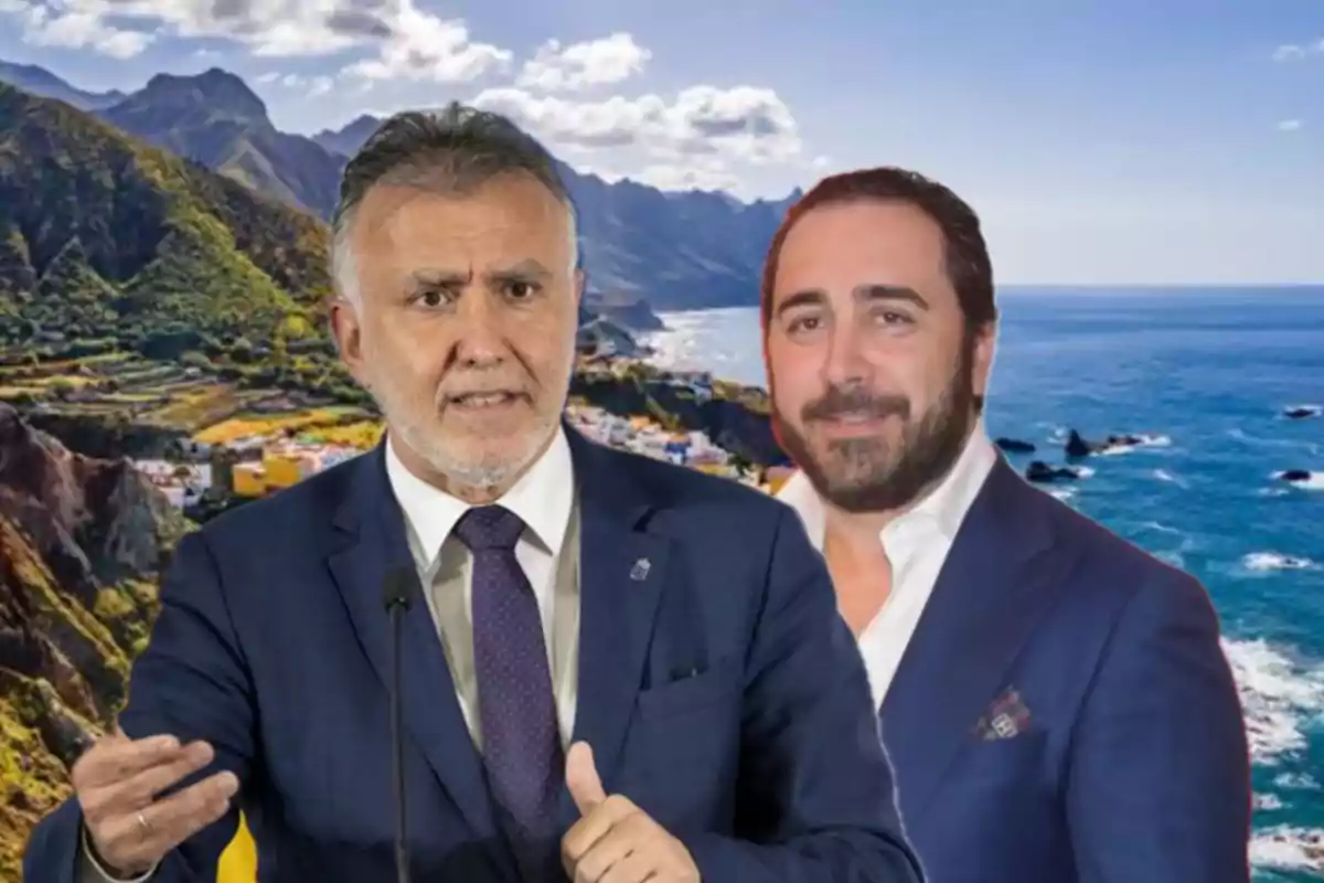 Dos hombres con traje posan frente a un paisaje costero con montañas y mar bajo un cielo parcialmente nublado