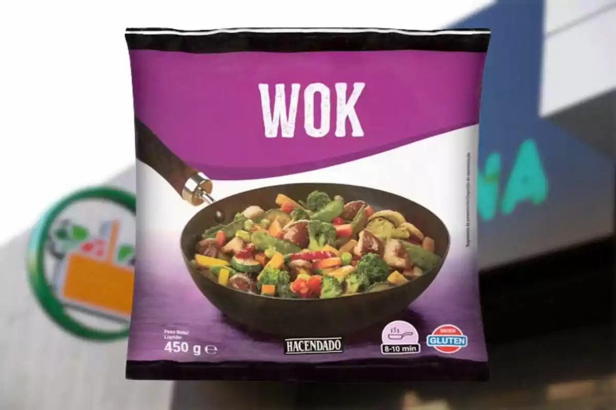 Bolsa de verduras congeladas para wok de la marca Hacendado con fondo de supermercado desenfocado Bolsa de verduras congeladas para wok de la marca Hacendado con fondo de supermercado desenfocado