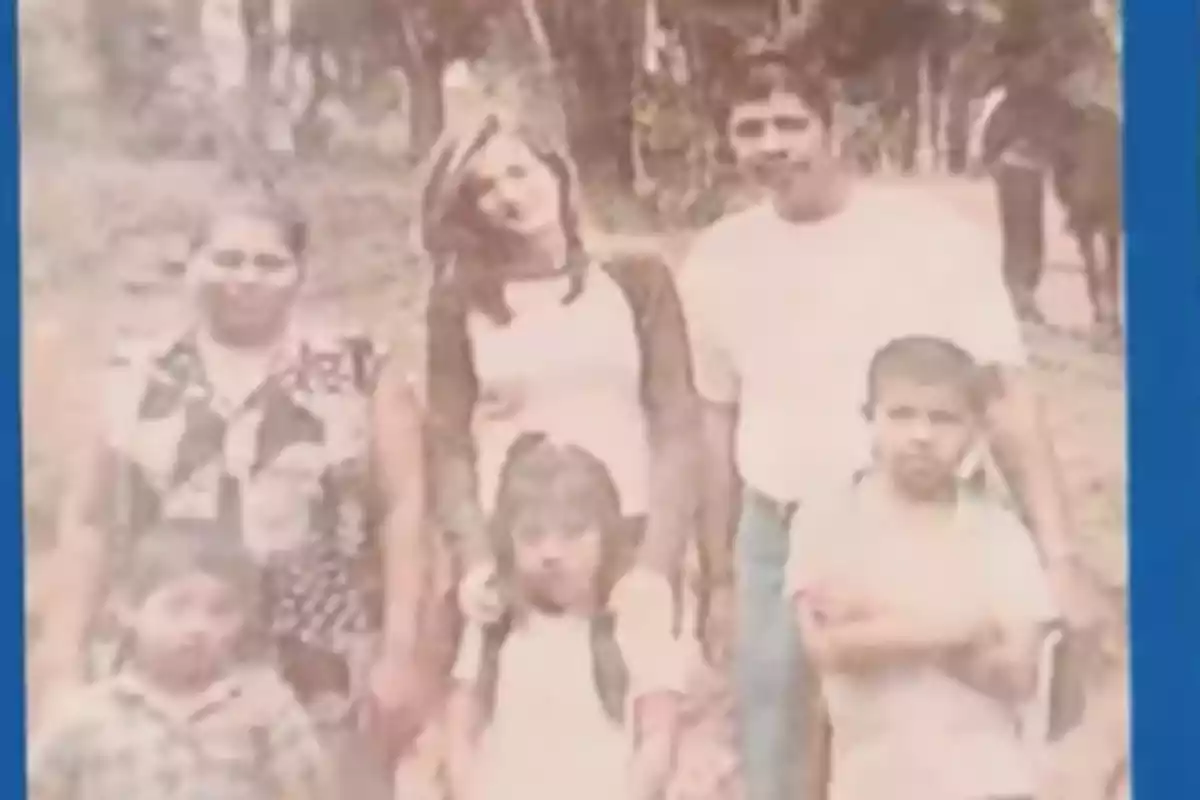 Old photograph of a family posing outdoors in a natural setting Old photograph of a family posing outdoors in a natural setting