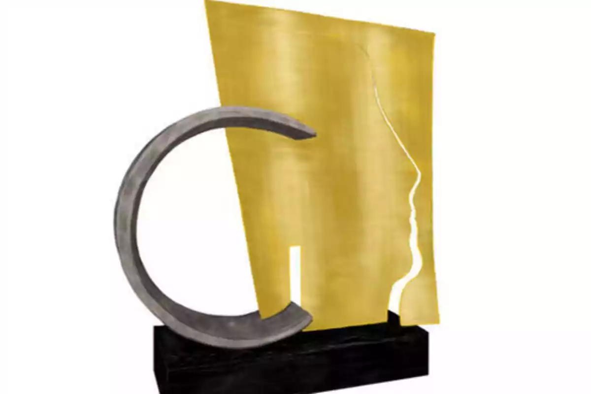 Escultura abstracta con una figura dorada y un semicírculo gris sobre una base negra.