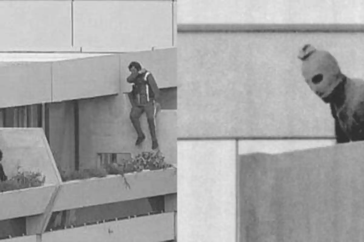Un hombre trepa por el balcón de un edificio mientras otra persona con una máscara observa desde una esquina.