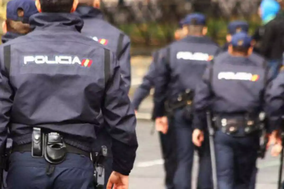 Policías uniformados caminando en formación.