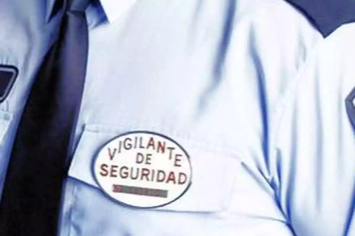 Uniforme de un vigilante de seguridad con una placa identificativa en el bolsillo.