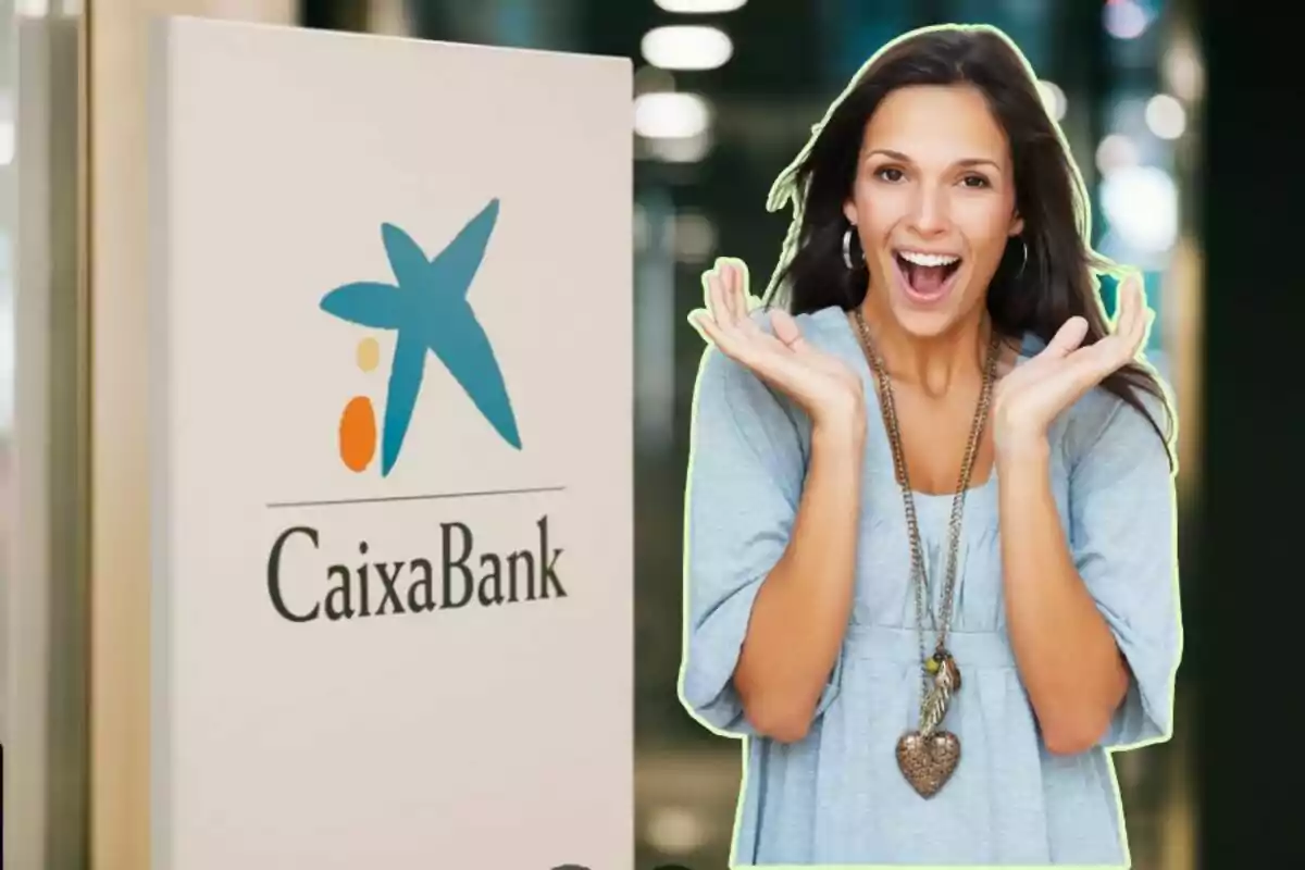 Una mujer sonriente con las manos levantadas junto a un cartel de CaixaBank.