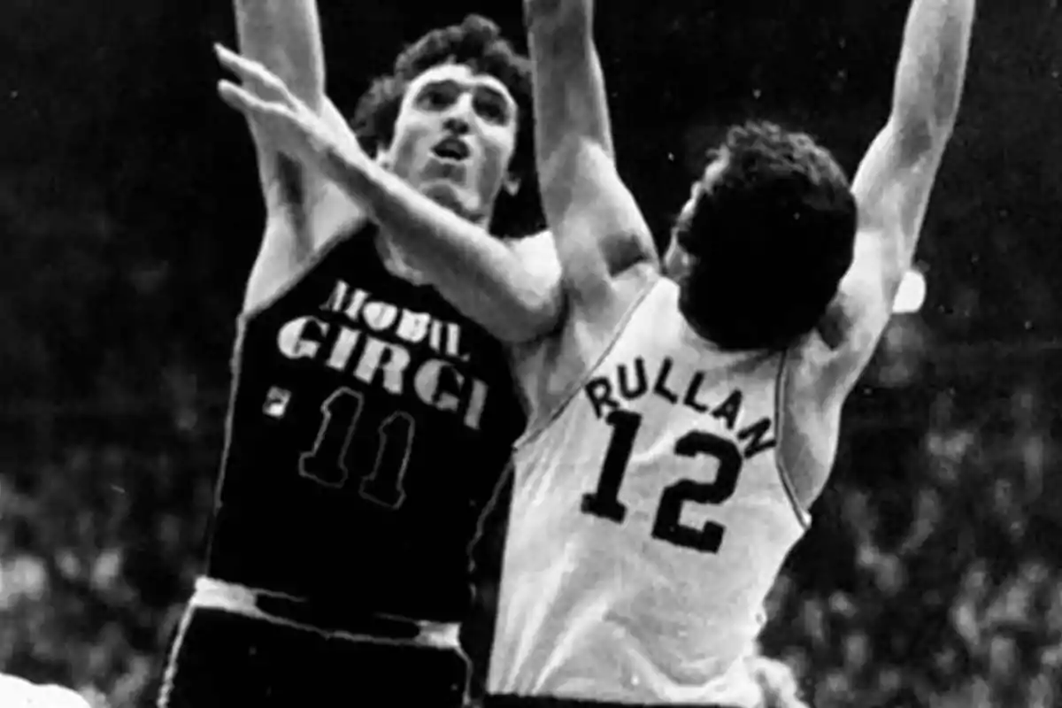 Dos jugadores de baloncesto compiten por el balón en un partido. Dos jugadores de baloncesto compiten por el balón en un partido.