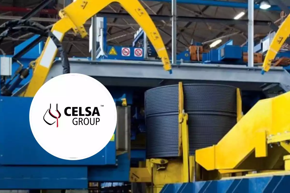 Maquinaria industrial amarilla y azul en una fábrica con un rollo de acero y el logotipo de CELSA Group en primer plano