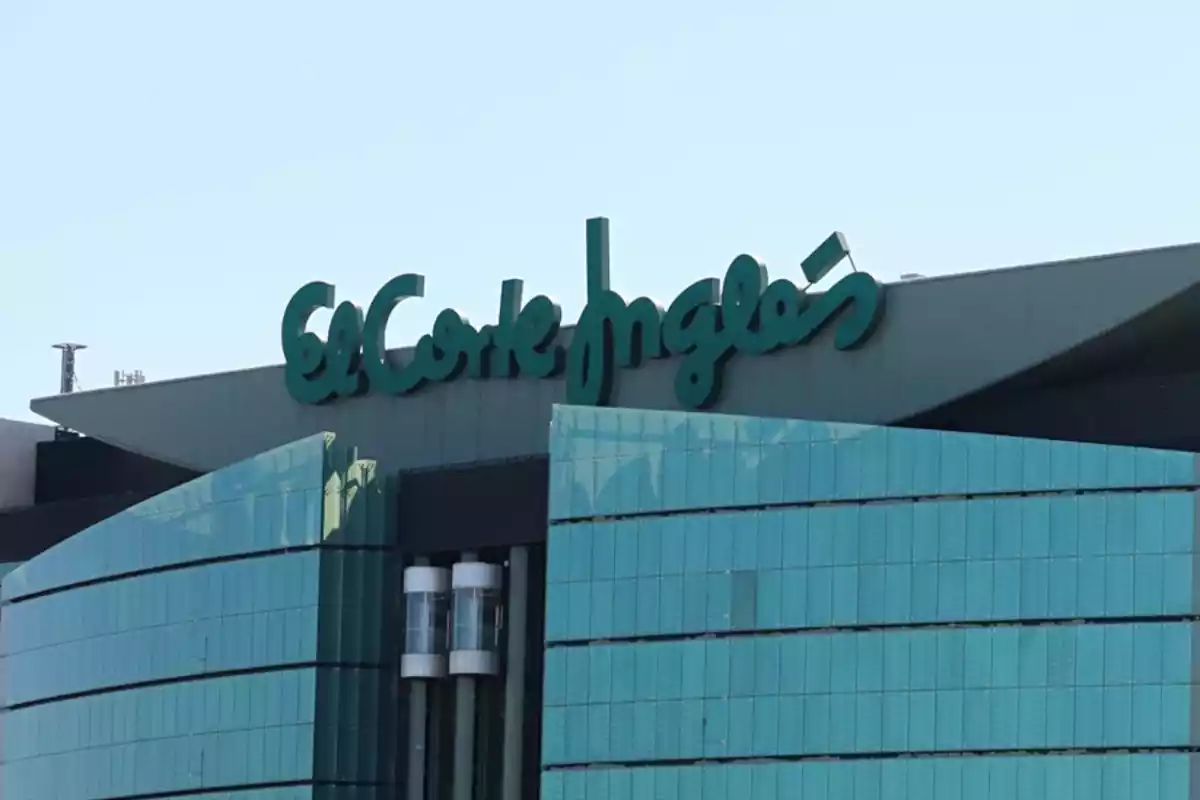 Upper part of the exterior of an El Corte Inglés shopping center with the large sign Upper part of the exterior of an El Corte Inglés shopping center with the large sign