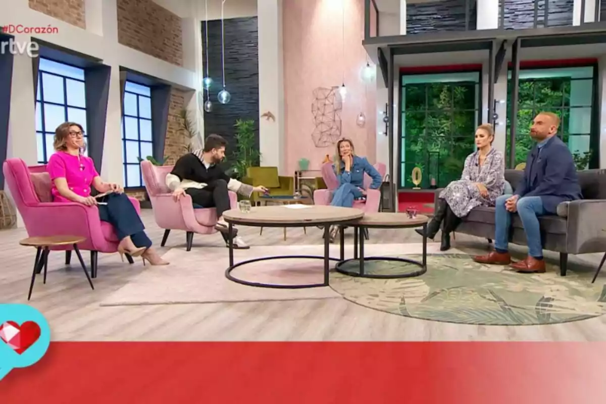 Un grupo de personas sentadas en un set de televisión moderno con decoración contemporánea y colores cálidos. Captura de 'D Corazón' Un grupo de personas sentadas en un set de televisión moderno con decoración contemporánea y colores cálidos. Captura de 'D Corazón'