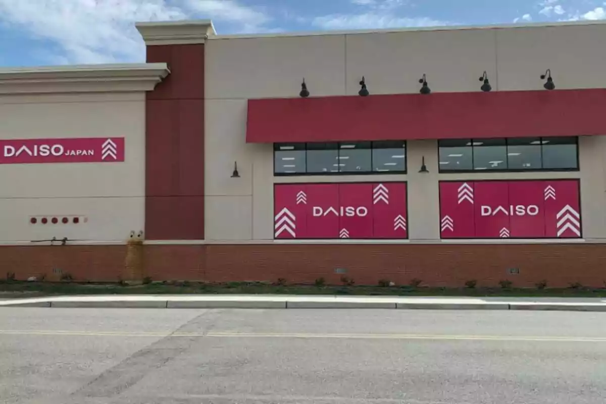 Storefront of a Daiso Japan shop with signs and windows decorated in pink Storefront of a Daiso Japan shop with signs and windows decorated in pink