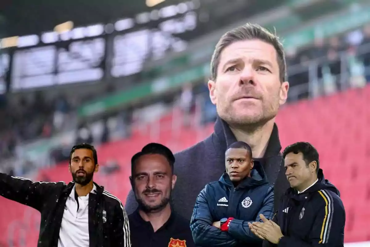 Un grupo de hombres con ropa deportiva se encuentra en un estadio, con uno de ellos en primer plano y los demás en una fila más cercana al frente.