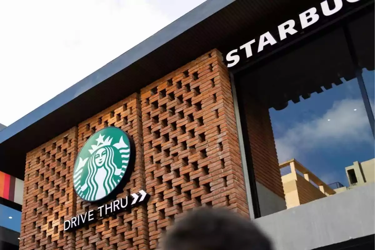Facade of a coffee shop with a drive-thru sign and a brick design. Facade of a coffee shop with a drive-thru sign and a brick design.