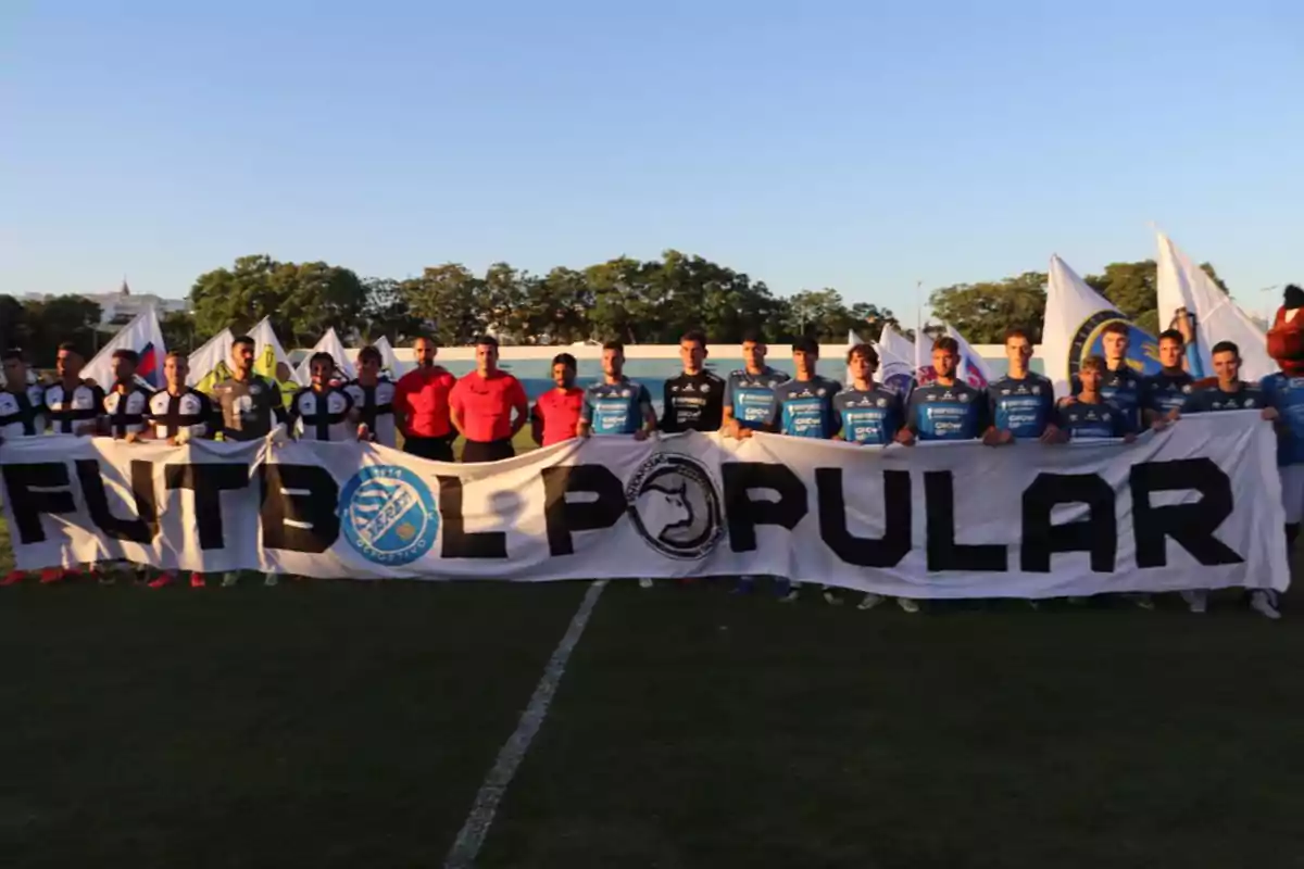 Un grupo de jugadores de fútbol sostiene una pancarta que dice 