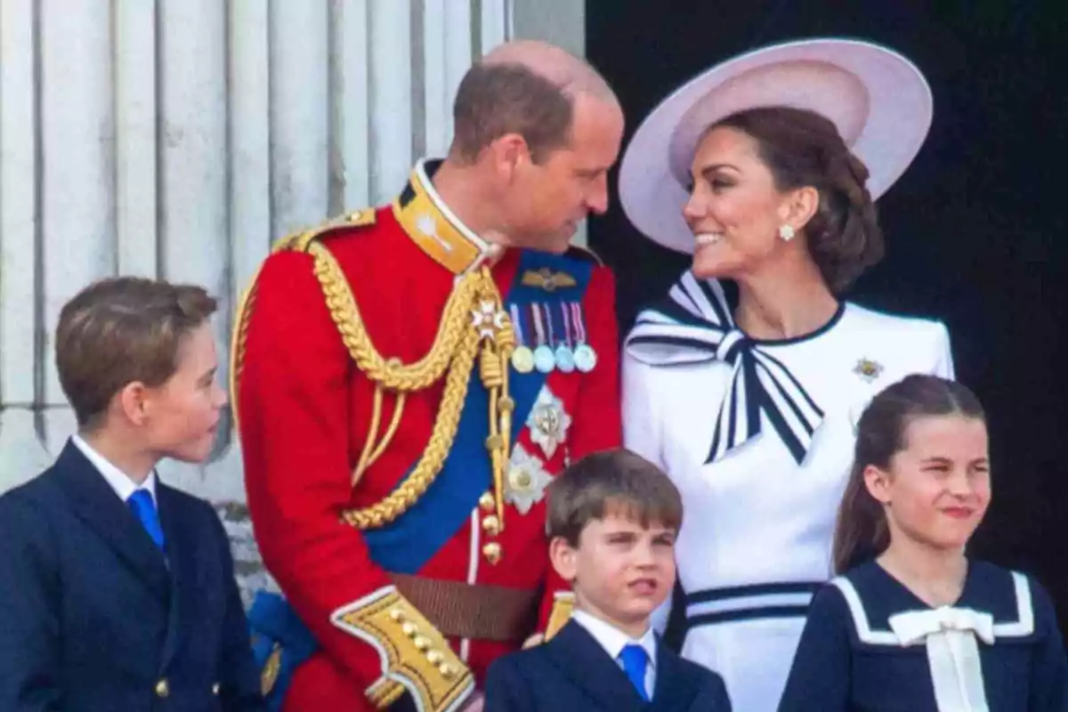 Prince William, Kate Middleton and their children George, Charlotte and Louis dressed elegantly smile while standing in front of a building with columns. Prince William, Kate Middleton and their children George, Charlotte and Louis dressed elegantly smile while standing in front of a building with columns.