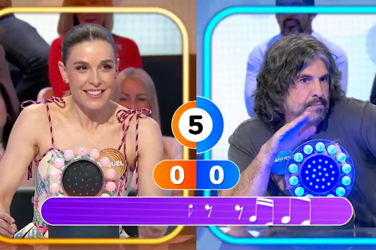 Raquel Sánchez Silva y J. J. Vaquero participan en 'Pasapalabra', cada uno con un pulsador luminoso frente a ellos y un marcador en el centro mostrando el número cinco y el puntaje en cero para ambos. Raquel Sánchez Silva y J. J. Vaquero participan en 'Pasapalabra', cada uno con un pulsador luminoso frente a ellos y un marcador en el centro mostrando el número cinco y el puntaje en cero para ambos.