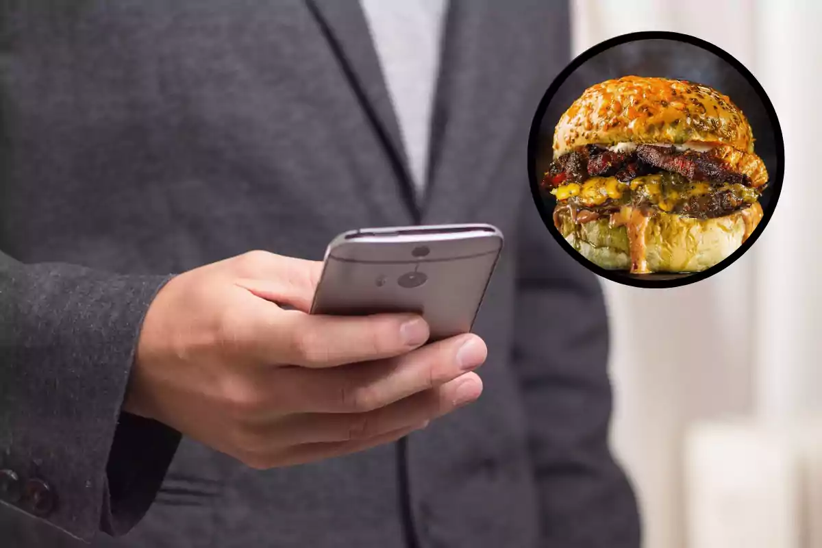 Un hombre con traje sostiene un teléfono móvil mientras aparece una imagen de una hamburguesa en un círculo.