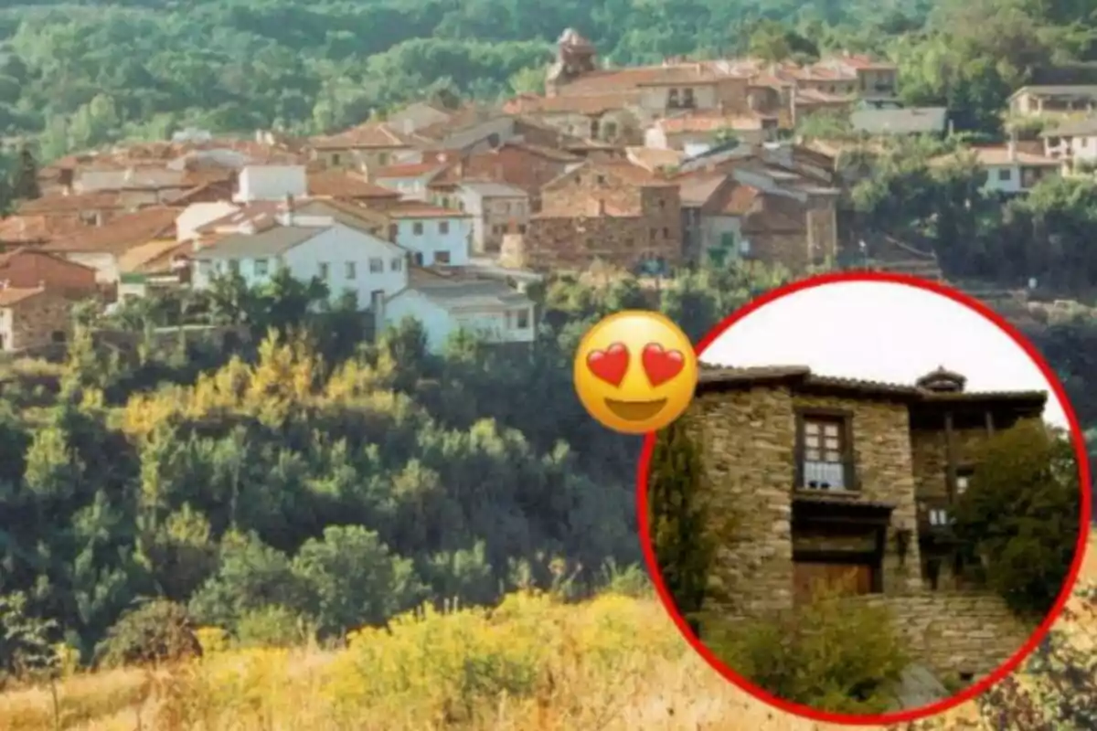 Vista panorámica de un pueblo con casas de tejados rojos rodeado de vegetación y un emoji de ojos de corazón sobre una casa de piedra en un círculo rojo.