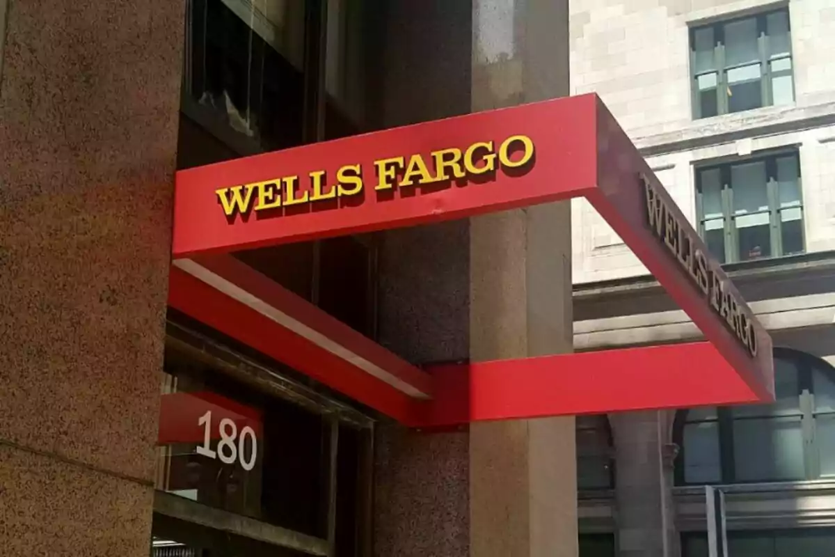 A red Wells Fargo sign at the entrance of a building. A red Wells Fargo sign at the entrance of a building.