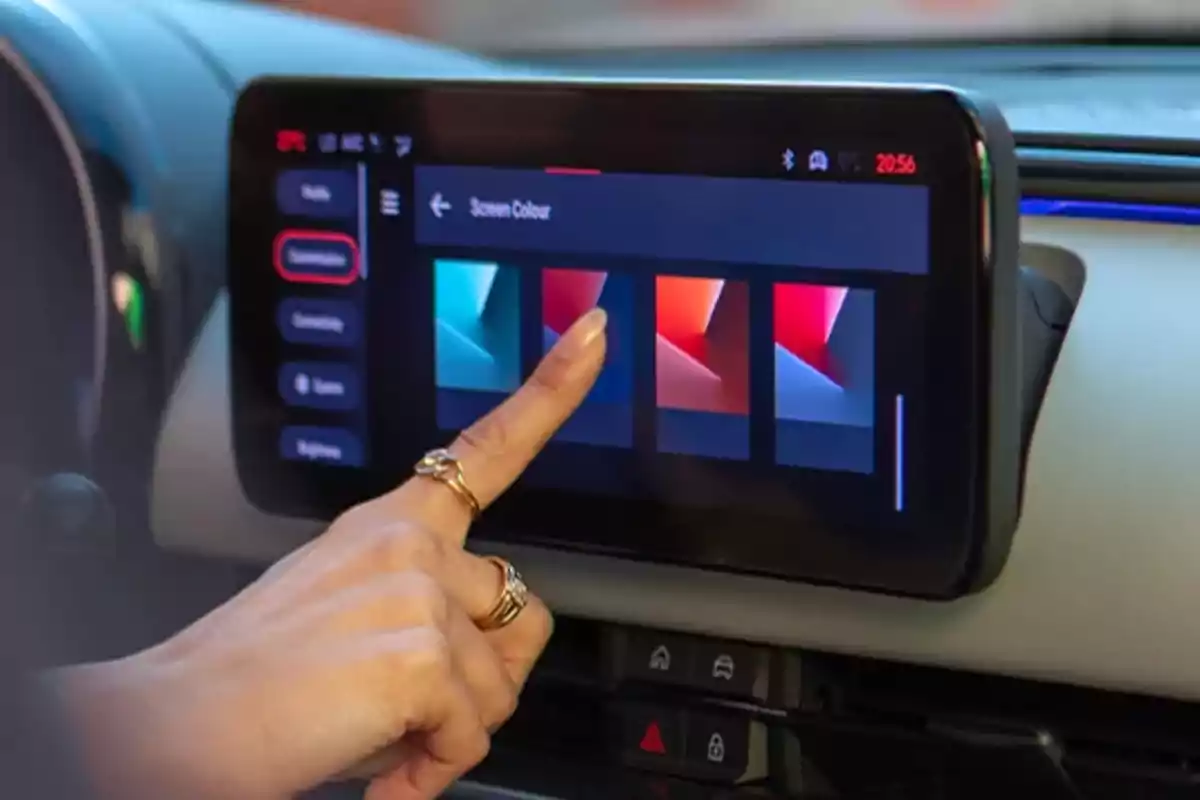 Una mano interactúa con la pantalla táctil de un FIAT 600 Hybrid seleccionando opciones de color.