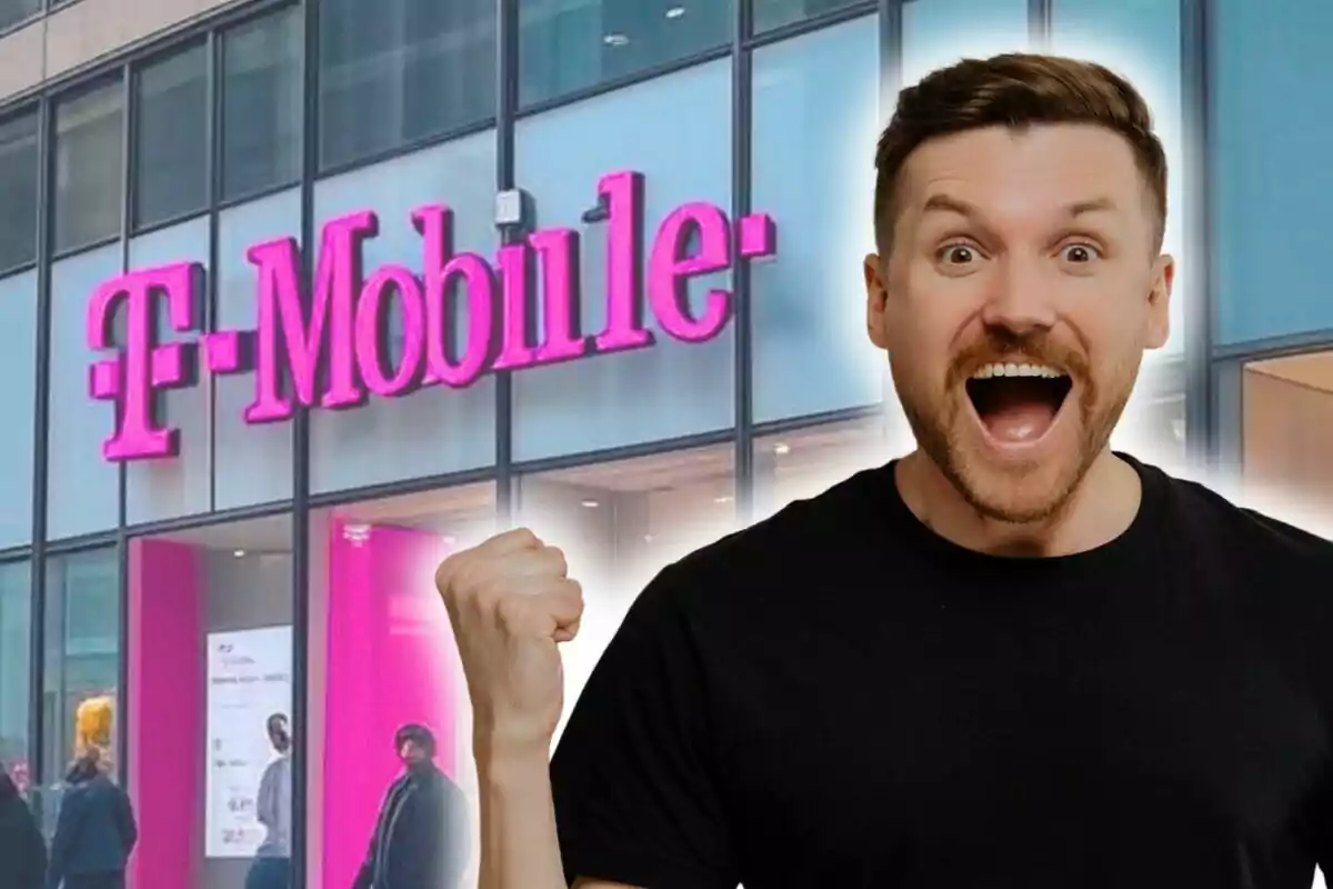Un hombre emocionado con el puño levantado frente a una tienda de T-Mobile. Un hombre emocionado con el puño levantado frente a una tienda de T-Mobile.