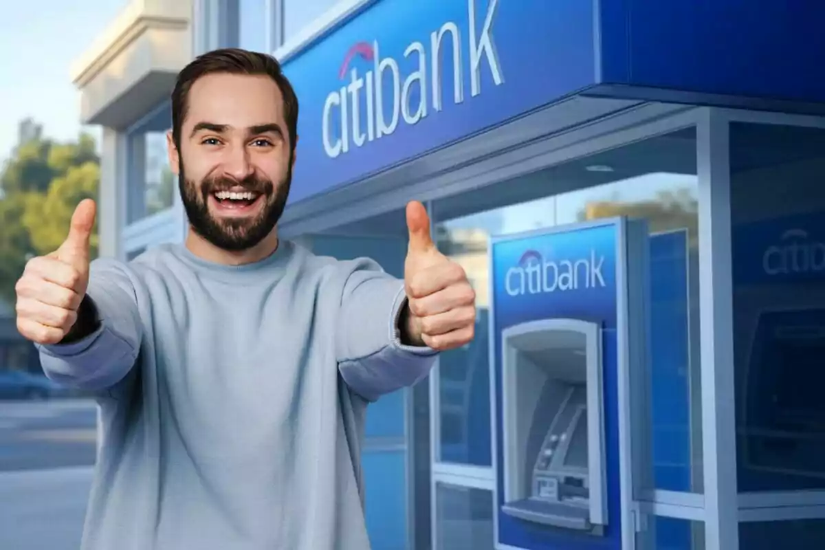 A smiling man with thumbs up in front of a Citibank ATM.