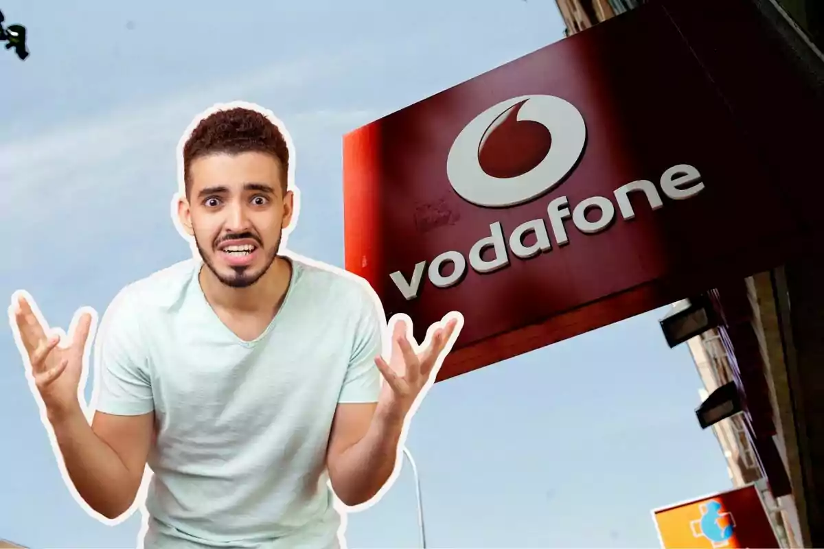 Un hombre con expresión de frustración frente a un cartel de Vodafone.