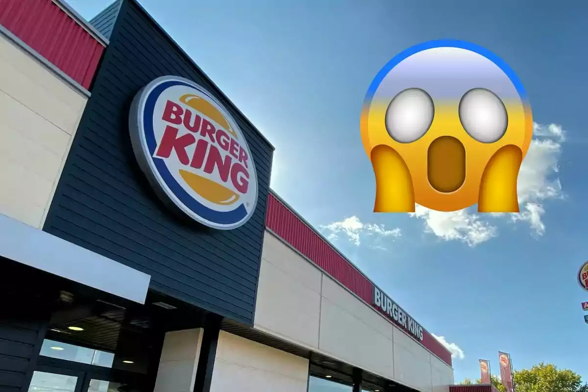 Frente de un restaurante Burger King con un emoji sorprendido en el cielo.