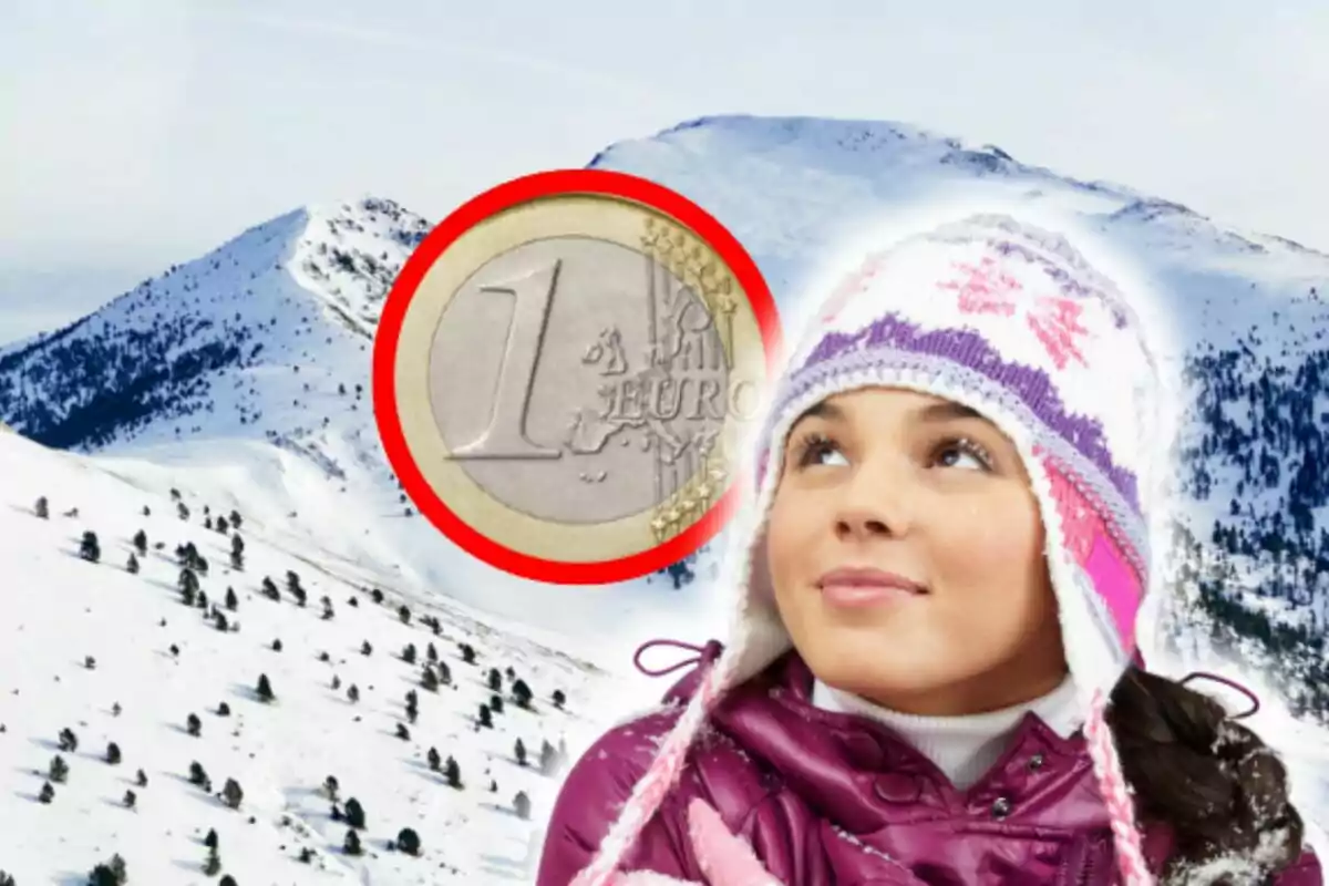 Una niña con gorro de invierno mira hacia arriba con una moneda de un euro sobre un fondo de montañas nevadas en Andorra.