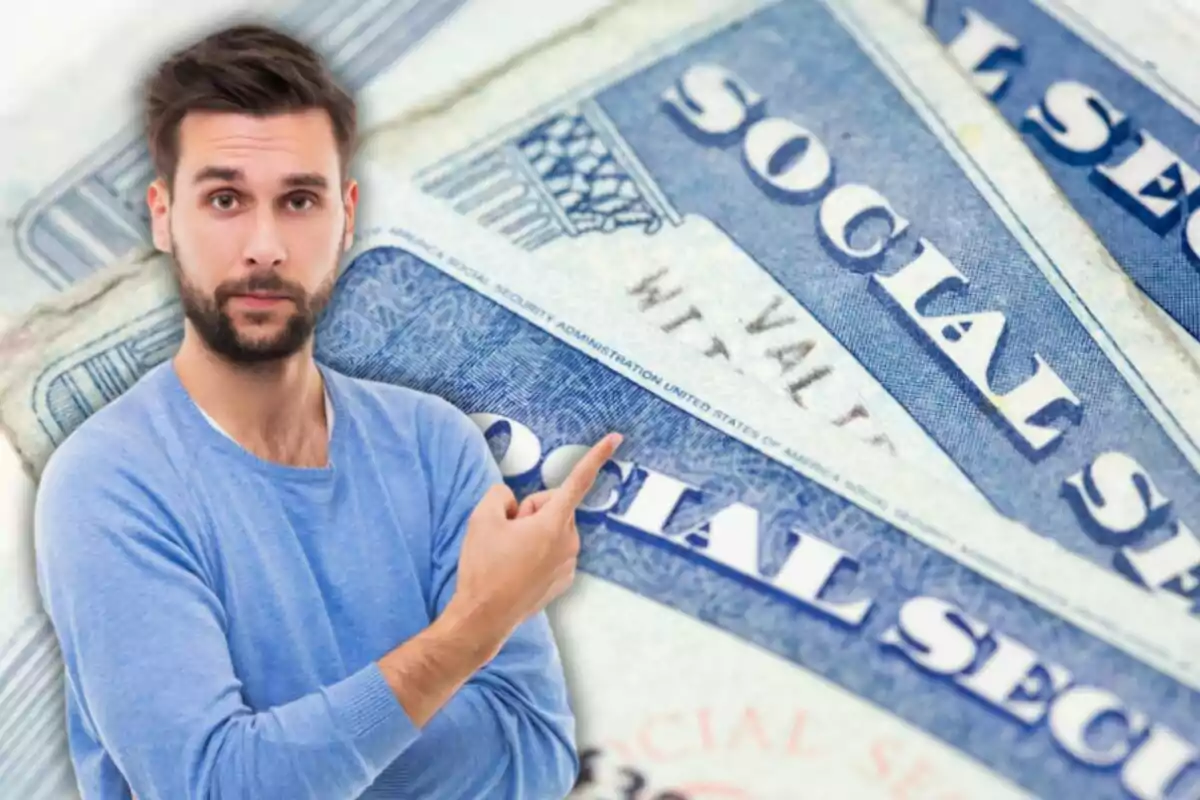 Man with a beard and blue sweater pointing toward several United States Social Security cards in the background