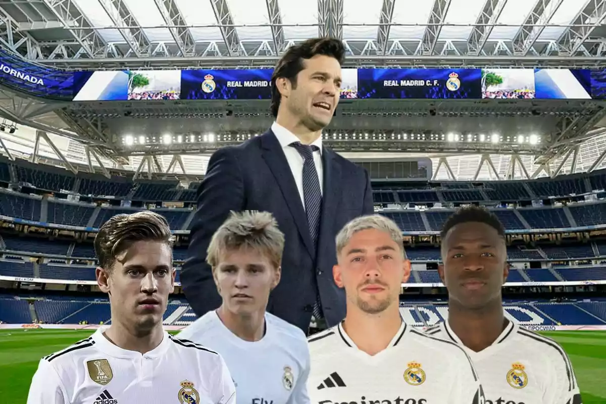 Un grupo de jugadores de fútbol con uniformes del Real Madrid posan en un estadio junto a un hombre con traje.