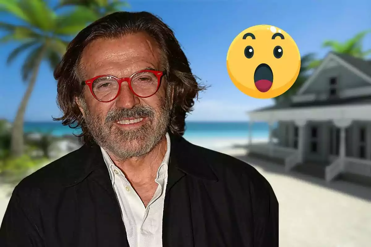 Un hombre con gafas rojas y barba sonríe frente a un fondo de playa con una casa y una palmera, acompañado de un emoji sorprendido.