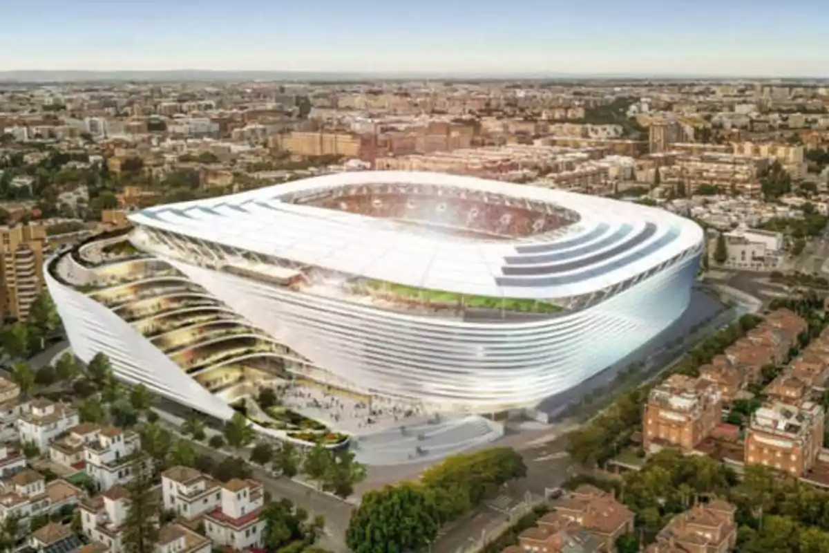 Vista aérea de un estadio moderno y futurista en una ciudad.