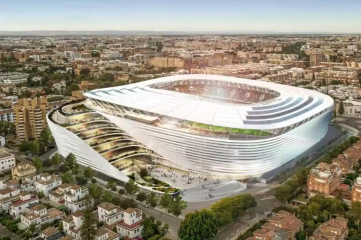 Vista aérea de un estadio moderno y futurista en una ciudad.