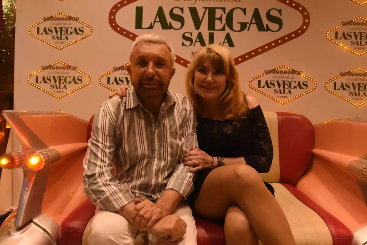 Una pareja sentada en un sofá con un fondo que dice "Las Vegas Sala Madrid".