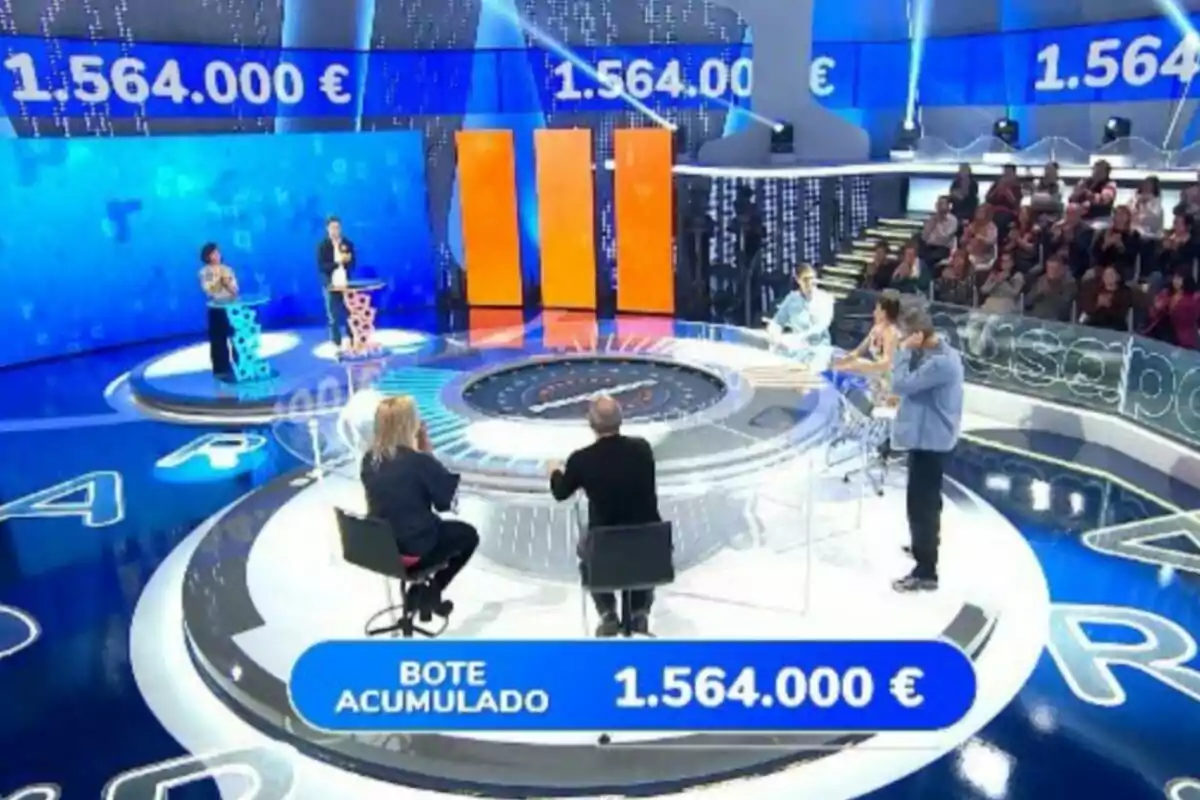 Un plató de concurso televisivo con participantes y un bote acumulado de 1.564.000 euros en la pantalla. Captura de 'Pasapalabra' Un plató de concurso televisivo con participantes y un bote acumulado de 1.564.000 euros en la pantalla. Captura de 'Pasapalabra'