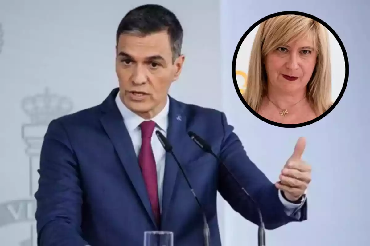 Hombre de traje azul hablando en una conferencia de prensa con la imagen de una mujer rubia en un círculo en la esquina superior derecha