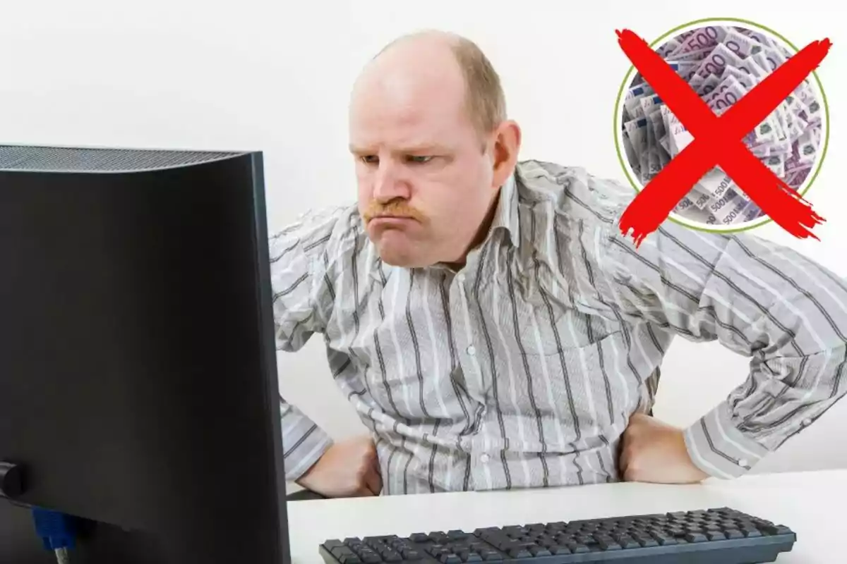 Hombre mirando una computadora con expresión seria y un símbolo de prohibición sobre billetes en la esquina.