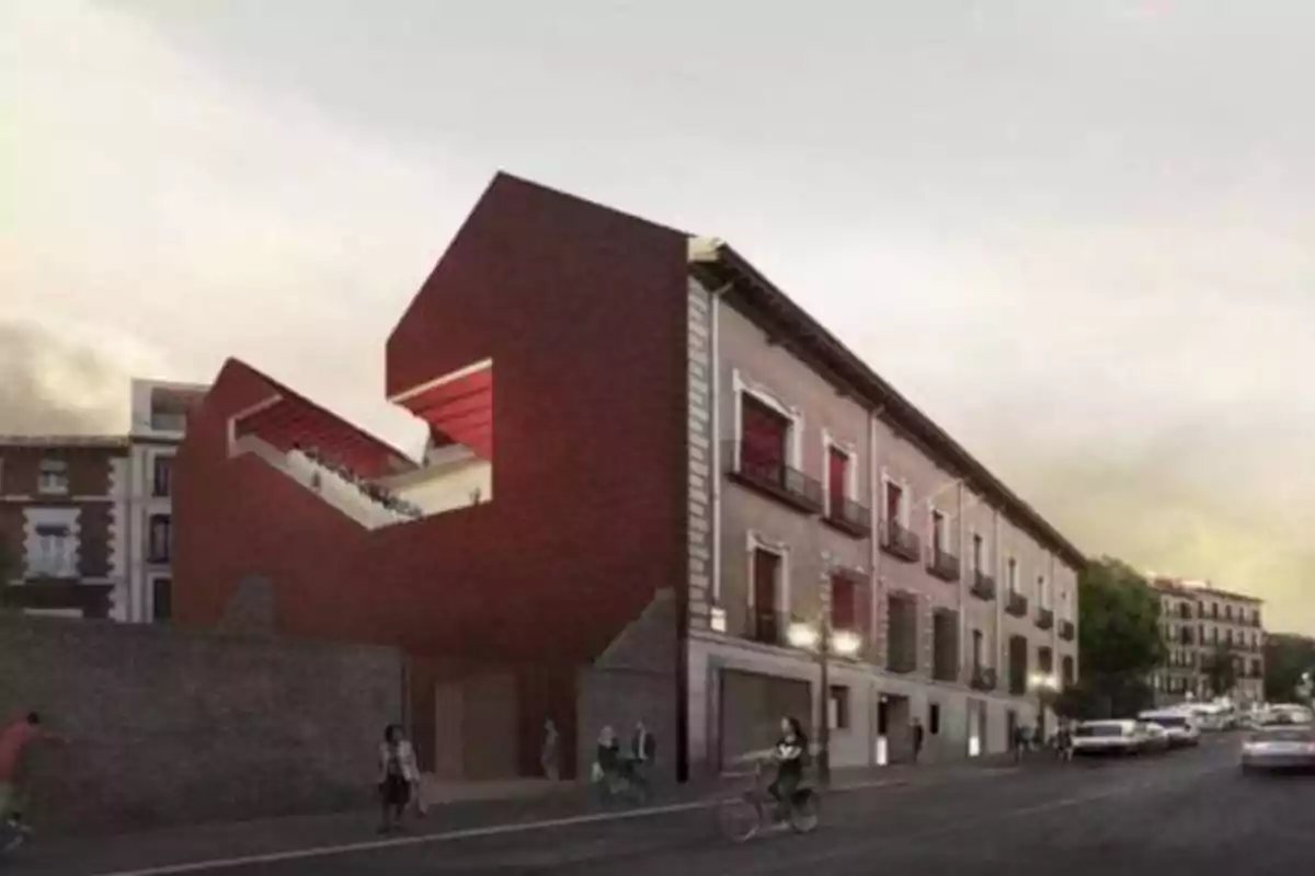 Edificio moderno de ladrillo rojo con una estructura angular en una calle urbana.