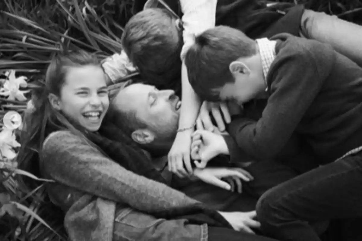 Group of people laughing and hugging while lying on the grass Group of people laughing and hugging while lying on the grass