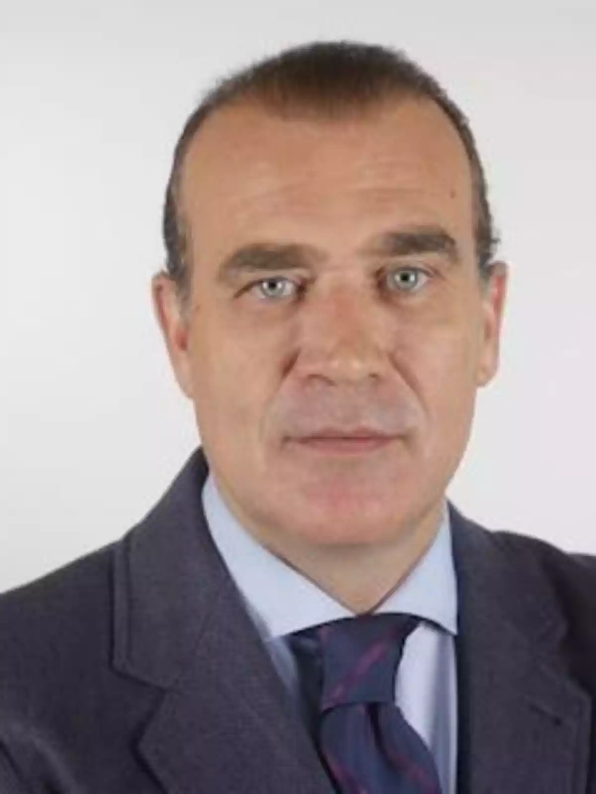Hombre de mediana edad con cabello corto y traje formal mirando al frente Hombre de mediana edad con cabello corto y traje formal mirando al frente